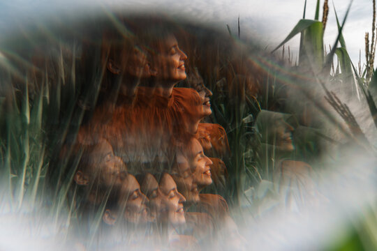 Woman laughing joyfully in blurred motion in a cornfield