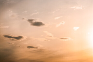 orange sky with small clouds during sunset