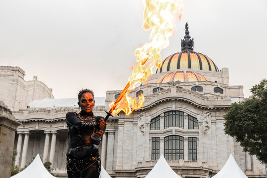 Performer in Catrina makeup breathes fire at Mexican event