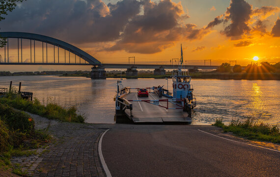 Landscape of Culemborg by sunset, view of the bridge over the Lek river and ferry crossing