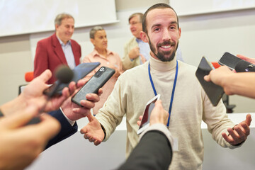 Speaker discussing with journalists through microphones at conference