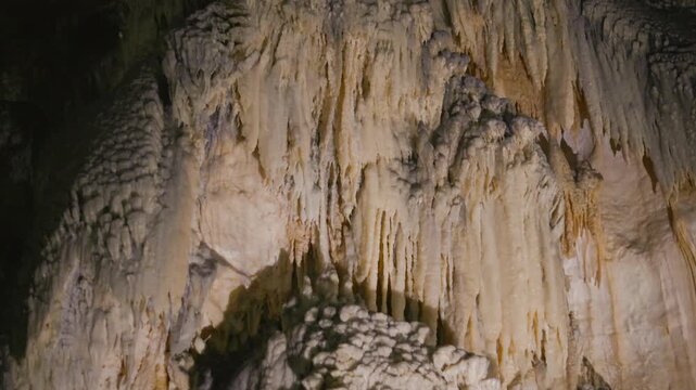 Frasassi Caves, rock wall covered with stalactites and unique rock formations.