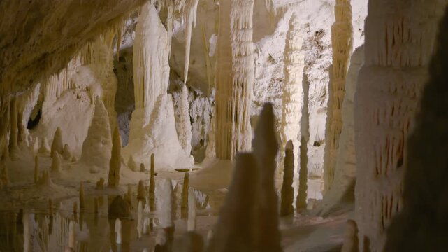 Frasassi Caves, underground exploration of the caves at the "hall of candles". Wonderful geological formations of very white stalactites and stalagmites. Geological wonders of the Marche, Italy