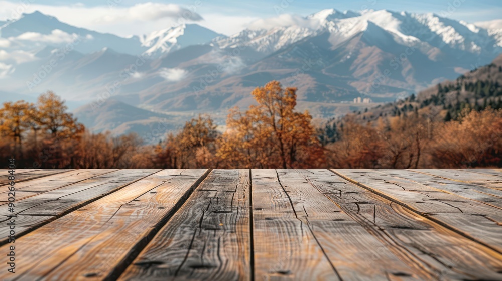 Poster a wooden table with a view of mountains in the background