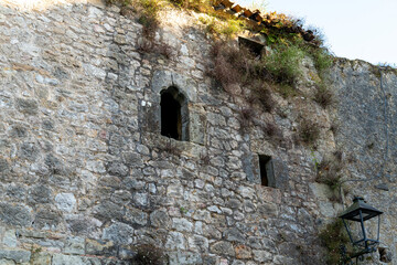 Quaint narrow alley with stone-paved path and historic buildings in Santillana del Mar, Spain. Perfect for travel, architecture, and cultural themes