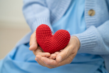 Asian doctor give red heart to elderly woman in her hand, heart Attack.