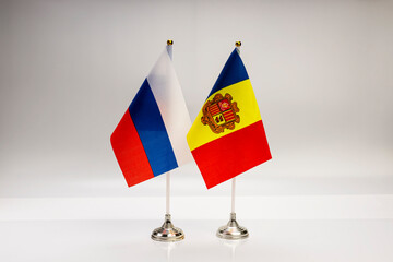 National flags of Russia and Andorra on a light background. State flags.