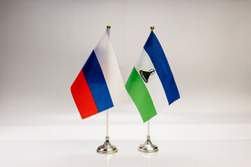 National flags of Russia and Lesotho on a light background. State flags.