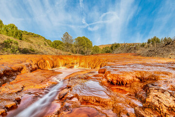 Rustic Riverbed Under Blue Sky