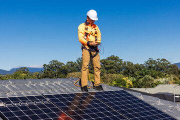 Solar panel technician with power meter and solar panels