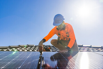 Solar panel technician with drill installing solar panels