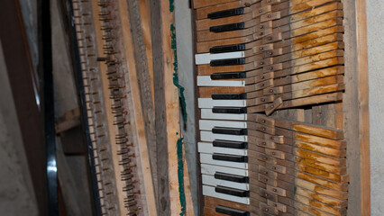 keys. black and white keys of an old piano. details of a musical instrument. close-up. disassembled, broken keyboard instrument, piano or grand piano, wood parts. vintage, retro. view from above