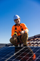 Solar panel technician with power meter and solar panels