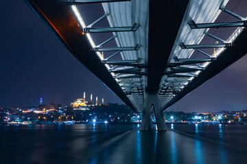 Istanbul metro station on the modern bridge on Golden Horn at sunset time.