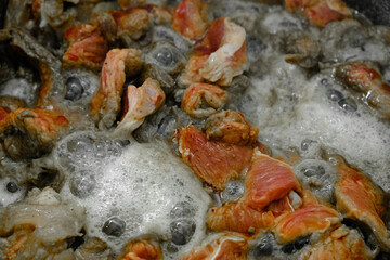 A closeup view of a pot filled with food that is foaming out of it
