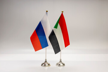 National flags of Russia and Sudan on a light background. State flags.