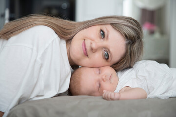 Fototapeta premium Mom with newborn baby in room at home. Motherhood. 