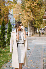 Business lady goes to the office in the morning to work and drinks coffee. Morning coffee on the way to the office.