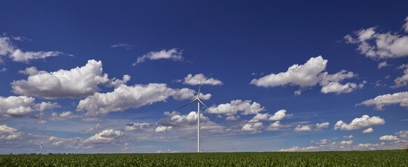 Elektrownia wiatrowa - wiatraki na tle błękitnego nieba z chmurami © arteffect.pl