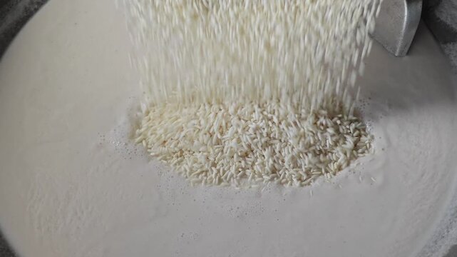 Pouring sticky rice in boiled coconut milk.