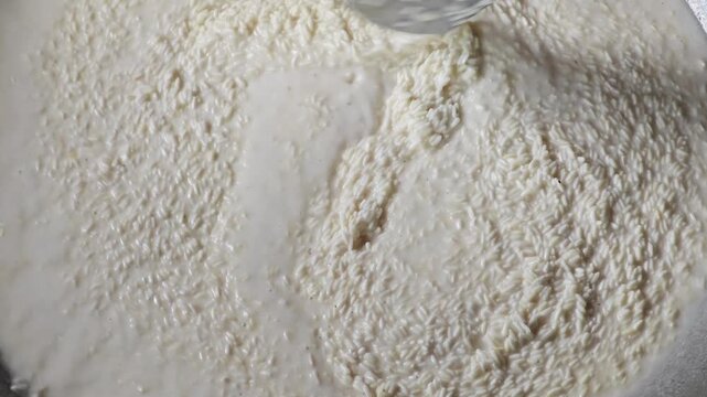 Stir Sticky Rice in Sweet Coconut Milk for Thai Desert.