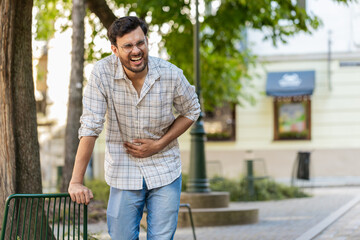 Arabian young man traveler feeling sudden strong abdominal stomach ache, gastritis problem. Upset...