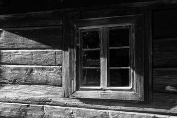 Wooden village window lit by the morning sun