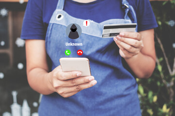 Scammer calls woman holding credit card.Woman holding credit card and smartphone ,Online shopping.