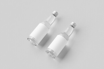 Miniature spirits, liquor bottle mockup. Clear glass and liquid with a blank label.