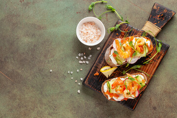 Sandwich with vegetables and prawns on a wooden board. Ciabatta sandwich.