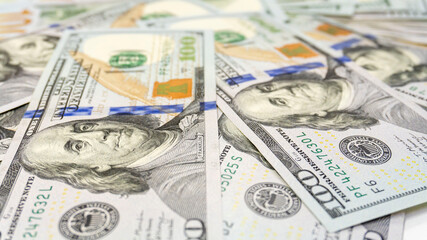 Close up view of cash dollar banknotes, 100 one hundred US dollar bills, 50 US dollar bills, 20 US dollar bills, lots of cash.