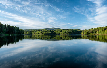 Vlasina lake beautiful summer scenery with beautiful clouds in the blue sky, reflected in the water. Beautiful semi-artificial lake in Southeast Serbia
