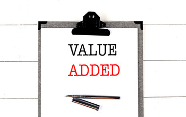 VALUE ADDE text on clipboard on white background