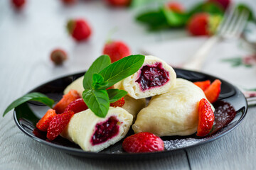 cooked sweet homemade steamed dumplings with strawberries