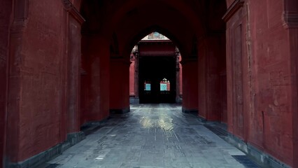 Fototapeta premium Ancient corridor under the arches with red