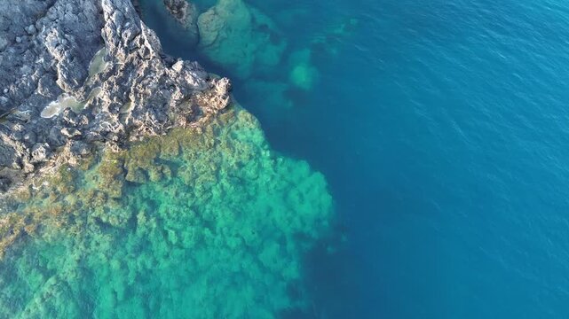 Aerial cinematographic view of gray rocks and blue sea on the Calabrian coast near Scalea city 3