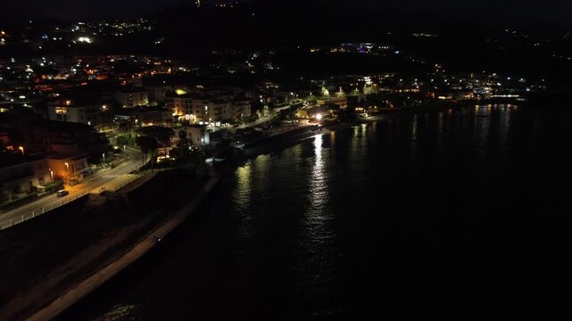 Breathtaking night aerial view over the seaside town of Diamante near Scalea in Calabria with the main street illuminated 3
