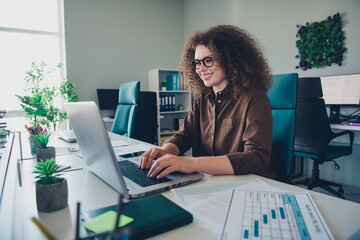 Photo of responsible charming successful woman working with modern device write news office indoors