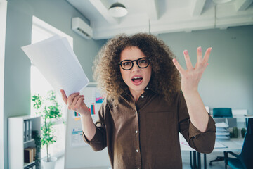 Photo of crazy furious mad lady boss hold document contract report mistake problem indoors
