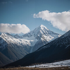 Fototapeta premium Snow covered mountains under a bright blue sky