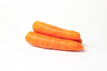 Front view and side view of fresh beautiful orange carrots with slices or pieces in a stack is isolated on white background with clipping path.