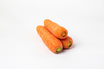 Front view and side view of fresh beautiful orange carrots with slices or pieces in a stack is isolated on white background with clipping path.