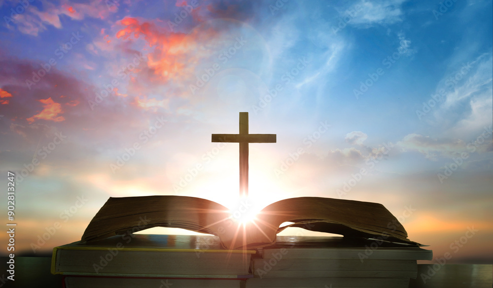 Wall mural open book with cross on sunset background. christian concept. 3d rendering