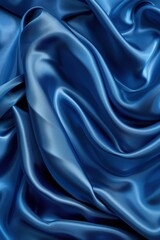 Fototapeta premium A blue fabric with a wave pattern. The fabric is smooth and shiny. The blue color gives a sense of calmness and serenity
