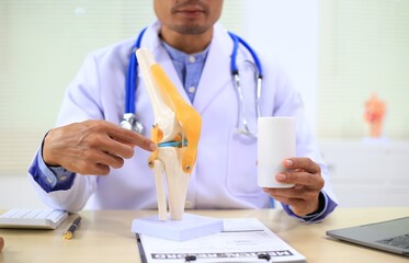 A male gynecologist examines prosthetic organs in a medical room, ensuring their quality and...