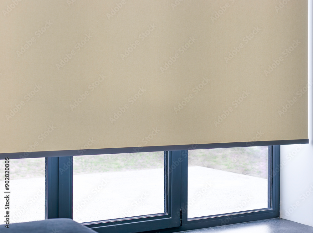 Aufkleber roller blinds on full height window. automated smart curtains indoors. a beige electric roller shade