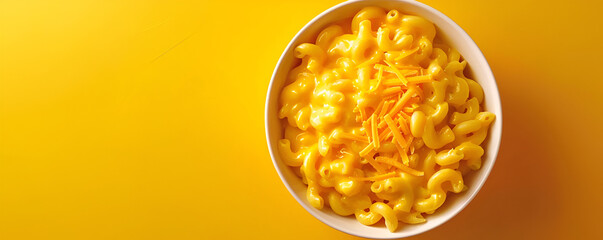 "Bowl of Creamy Macaroni and Cheese on Yellow Background"


