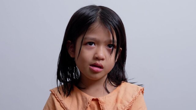 A Litter Asian girl sitting in room conner and crying after Punished by the blackout.