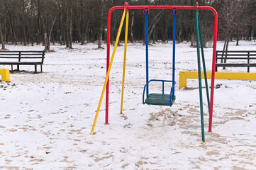 an empty children's swing n the park