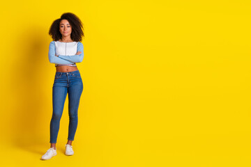 Full size photo of nice lovely girl dressed stylish shirt holding arms folded near empty space isolated on vibrant yellow color background